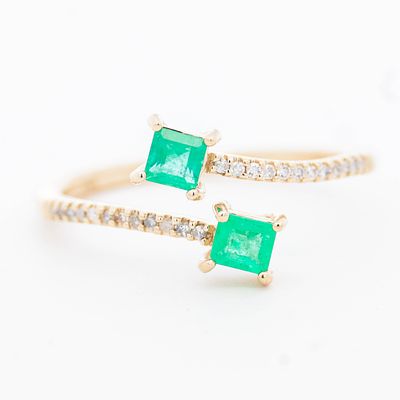 14K YG Emerald & Diamond Ring, size 7. 14K yellow gold bypass ring with two emeralds and pave 