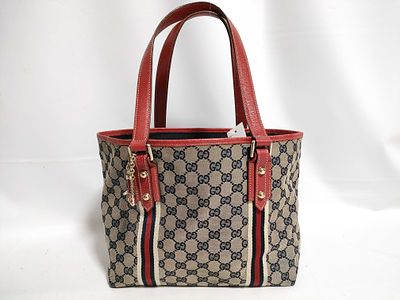 Gucci GG canvas and leather Jolicoeur tote bag with red leather trim and web stripe detail. 