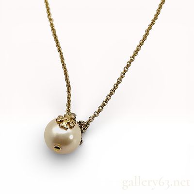 Tory Burch Gold-Tone Faux Pearl Logo Pendant Necklace. Tory Burch necklace featuring a round 