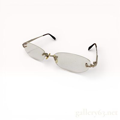 Burberry rimless eyeglasses with silver-tone metal bridge and temples. Clear oval lenses with 