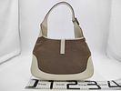 Gucci Jackie O Piston Lock Hobo Bag. Gucci Jackie hobo bag featuring a tan woven canvas body Image - 1