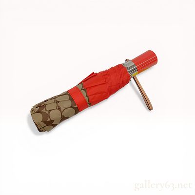 Two Coach Signature Monogram Items Including a Folding Umbrella and Matching Sleeve. Coach 