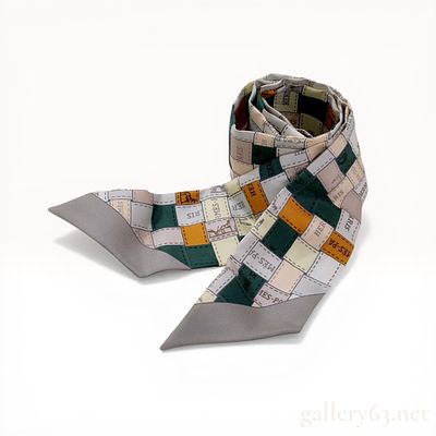 Hermes Silk Twilly Scarf in a Multicolor Patchwork Pattern. Hermes Twilly silk scarf featuring a 