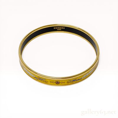 Hermes Narrow Enamel and Gold-Tone Bangle. Hermes narrow enamel bangle featuring a yellow 