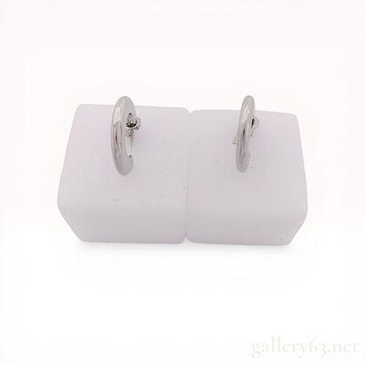 A Pair of Coach Silver-Tone C-Shaped Hoop Earrings. A pair of silver-tone metal C-shaped hoop 