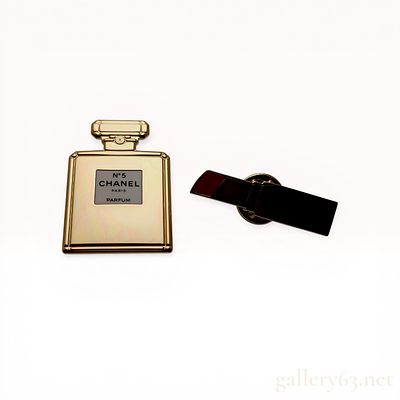 Two Chanel La Collection Gold-Toned Enamel Lapel Pins. A set of two Chanel La Collection 
