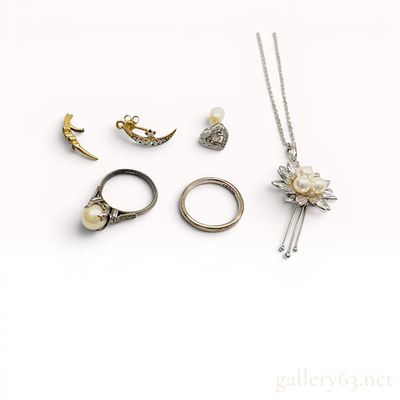 An Assortment of Vintage Jewelry. An assortment of jewelry including a white metal band, and a 