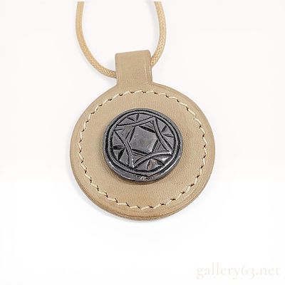 Hermes Leather and Metal Talisman Pendant Necklace, 2009. Hermes circular leather and metal 