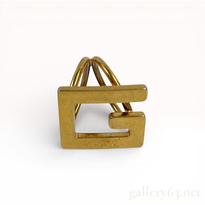 Gold-Plated Metal Gucci G Logo Scarf Ring. A Gucci G-motif scarf ring crafted in gold-plated 
