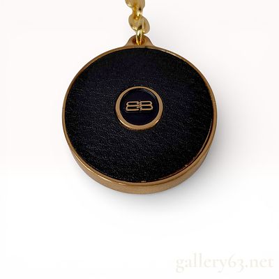 Balenciaga Black and Gold Round Logo Keychain Key Ring. Balenciaga keychain featuring a round 