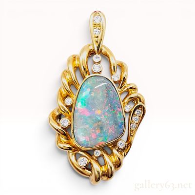 18K Yellow Gold Boulder Opal and Diamond Pendant. This 18 karat yellow gold pendant features a 