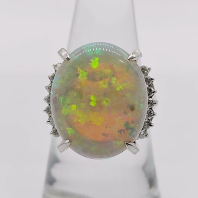 Platinum Oval Opal and Diamond Cocktail Ring. This platinum cocktail ring features a large 