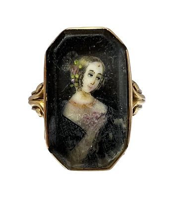 French miniature 18K gold ring with a figure of a lady holding flowers in her 