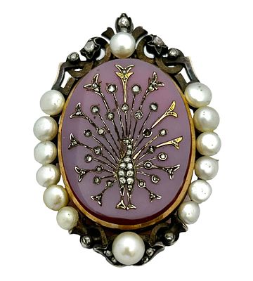 Antique cameo pendant with a purple agate background which changes to a reddish rosy shade in 