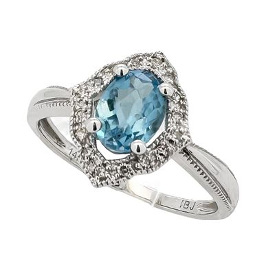 A classic 14K white gold ring set with 1.35ct of white diamonds and a blue topaz gemstone that