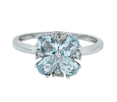 A floral 14K white gold ring set with aquamarine gemstones as flower petals and white diamonds