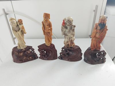 FOUR ORIENTAL FIGURES ON BASES