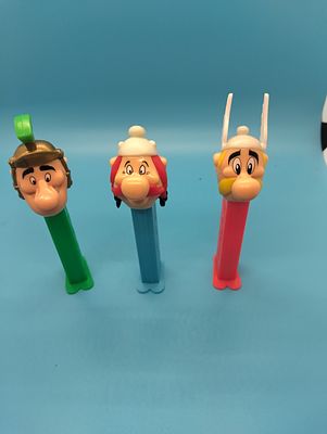THREE PEZ DISPENSERS INCLUDING ASTRIX, OBLIX AND A ROMAN