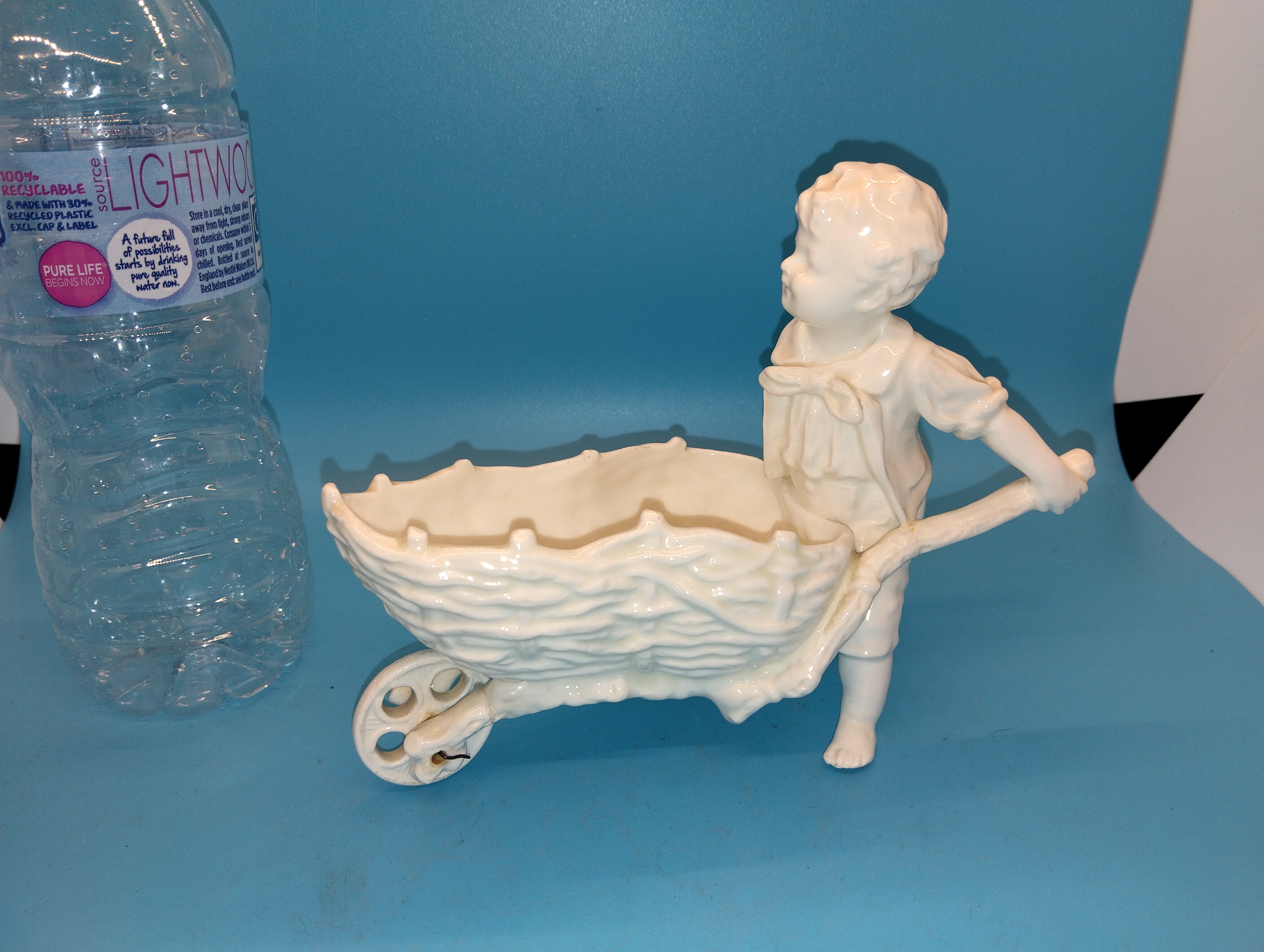 VERY NICE white glazed figure of a Boy pushing Barrow