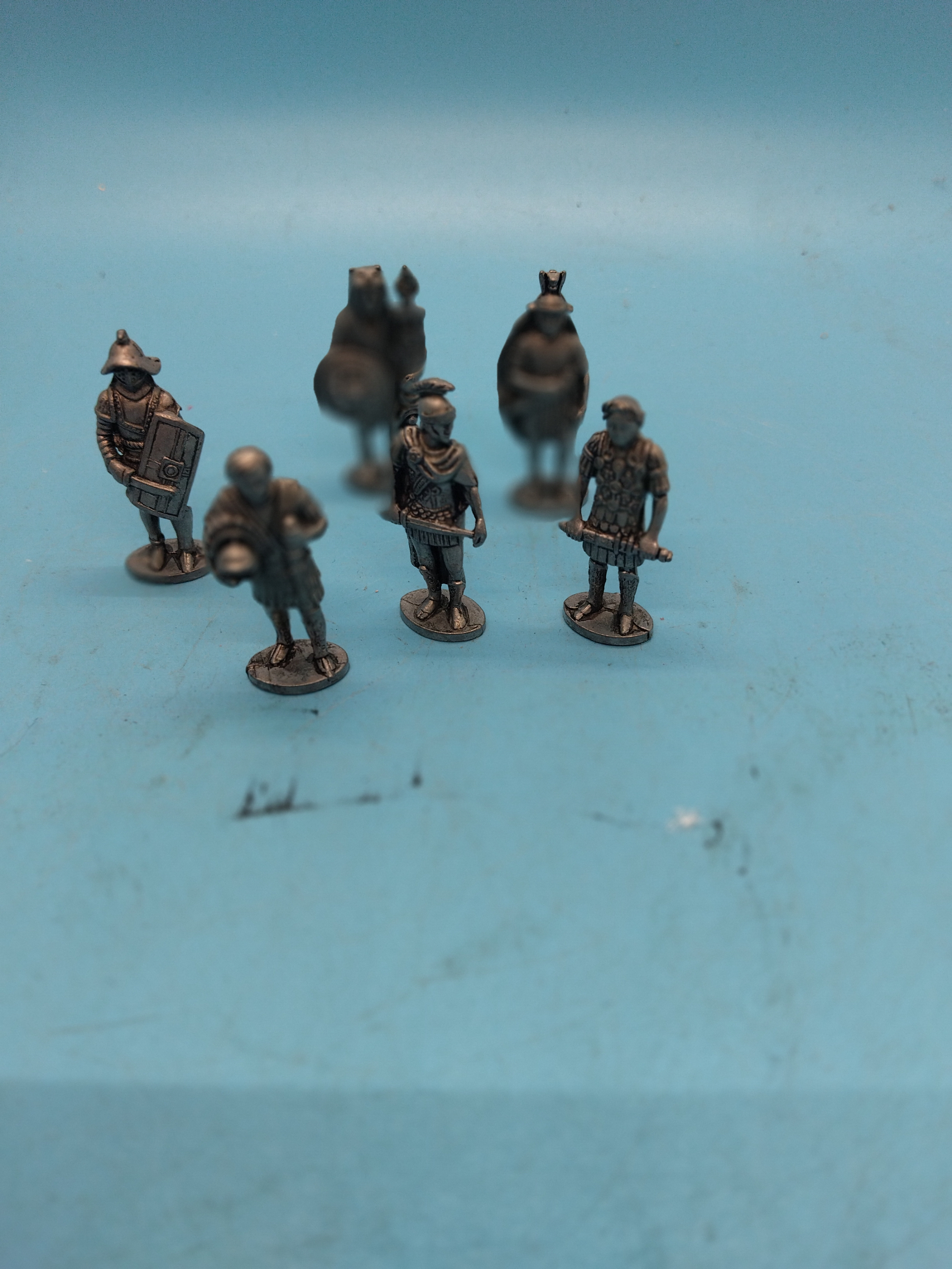 A SET OF SIX CAST METAL ANCIENT STYLE FIBURES