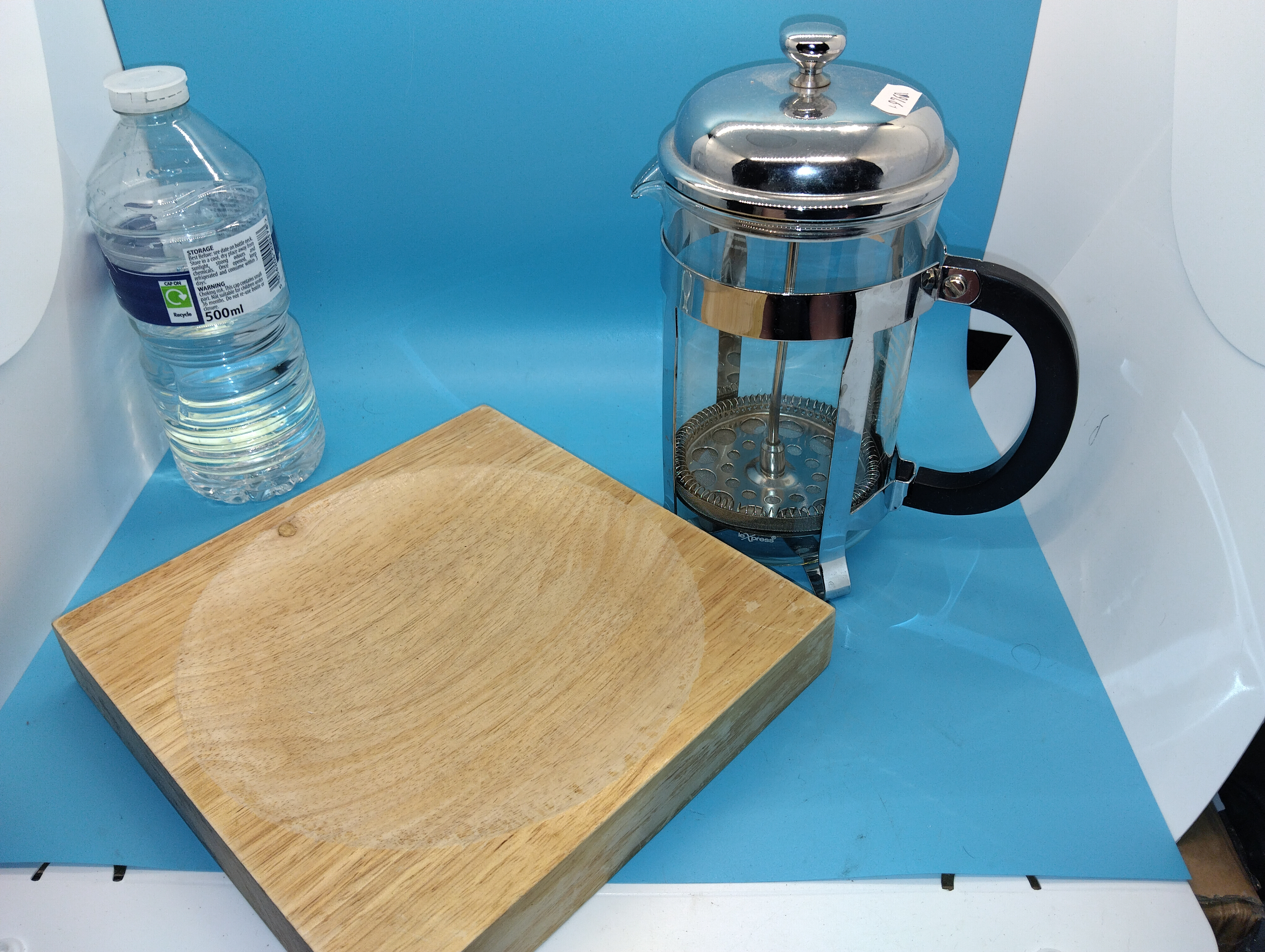 A Trio of Kitchenware Comprising an L'Express French Press, a Wooden Serving Board