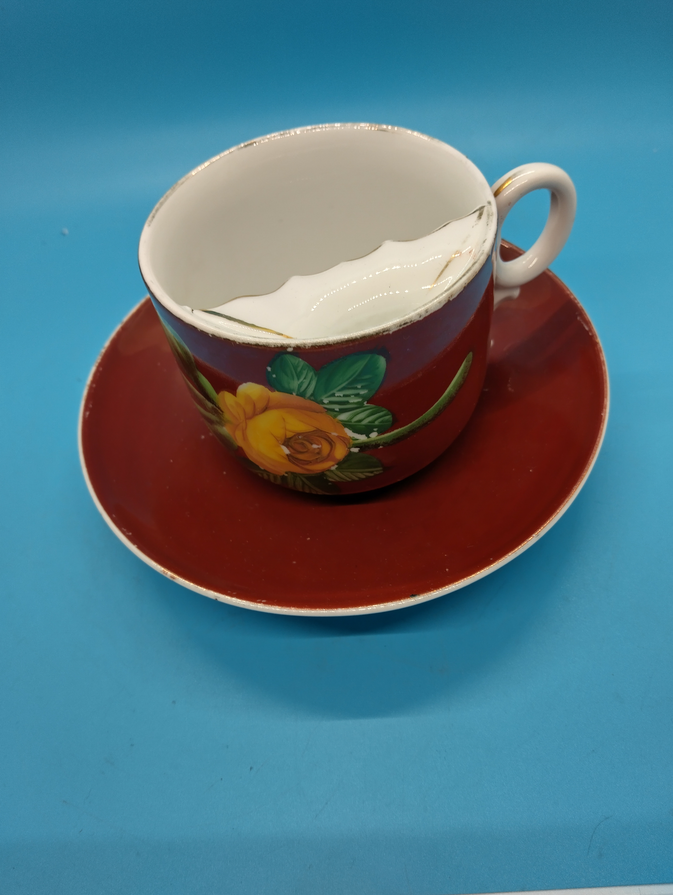 A Porcelain Moustache Cup and Saucer with Floral Decoration