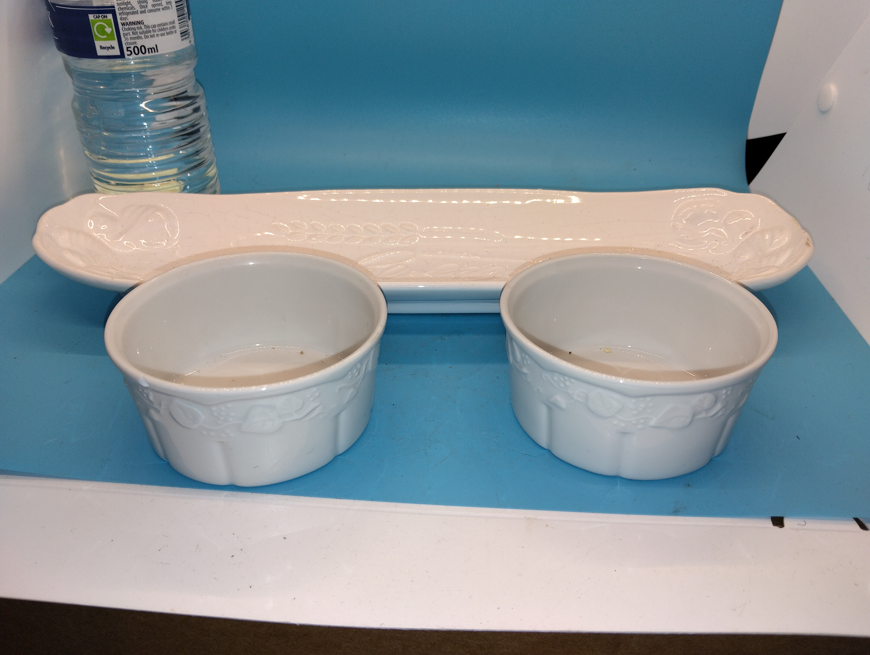 A Trio of White Glazed Ceramic Tableware Including a Garlic Bread Platter and Two Lierre Sauvage Ramekins