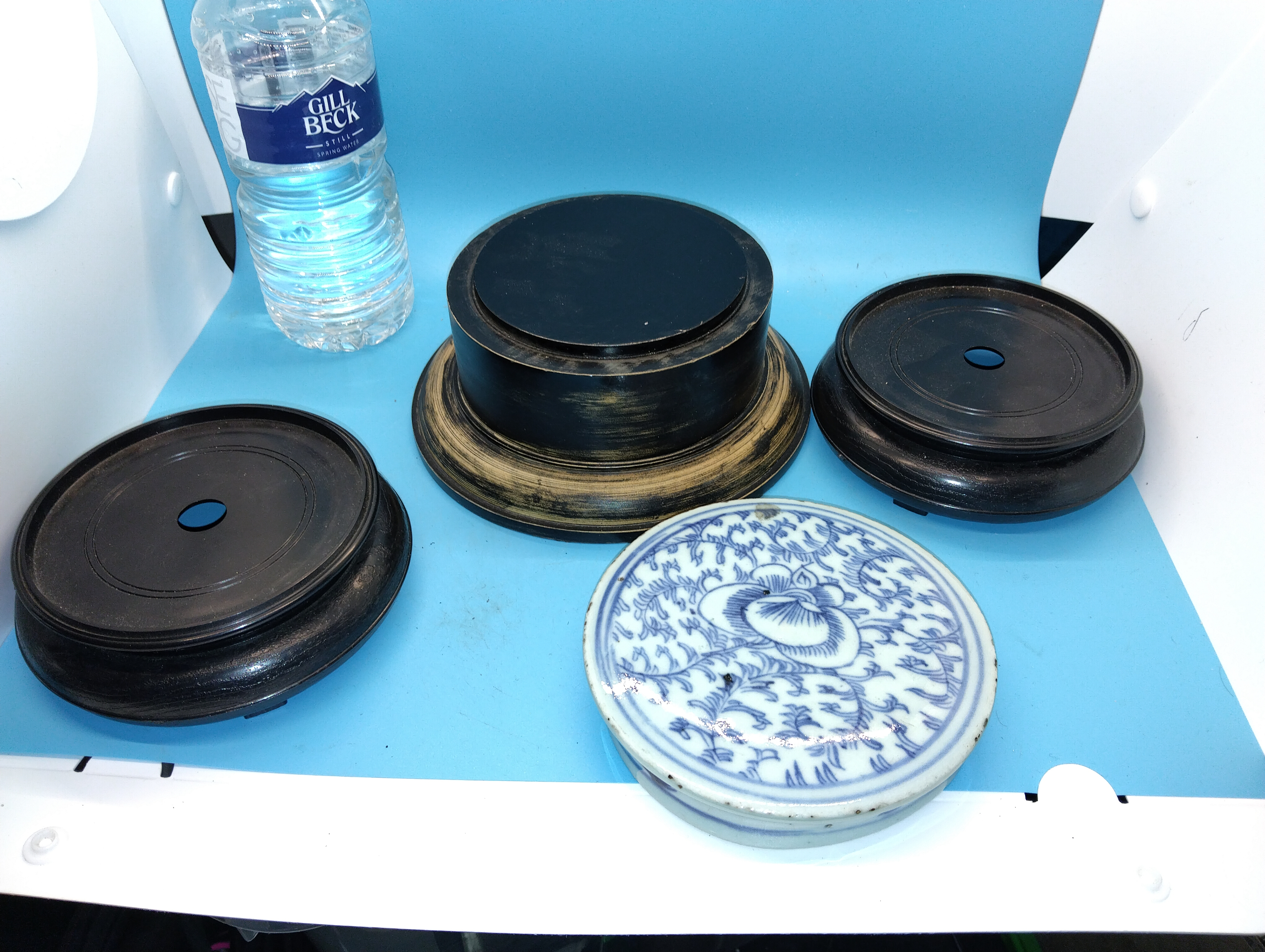 A Collection of Chinese Style Wooden Display Stands and a Blue and White Porcelain Box