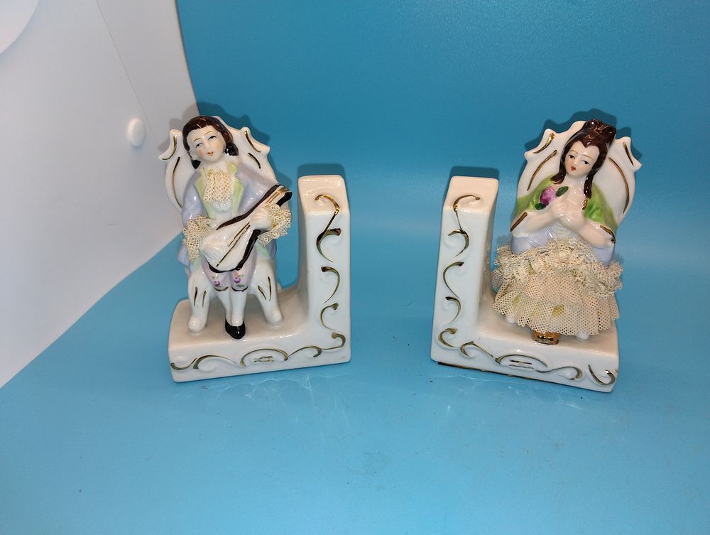 A Pair of Rococo Style Porcelain Figural Bookends