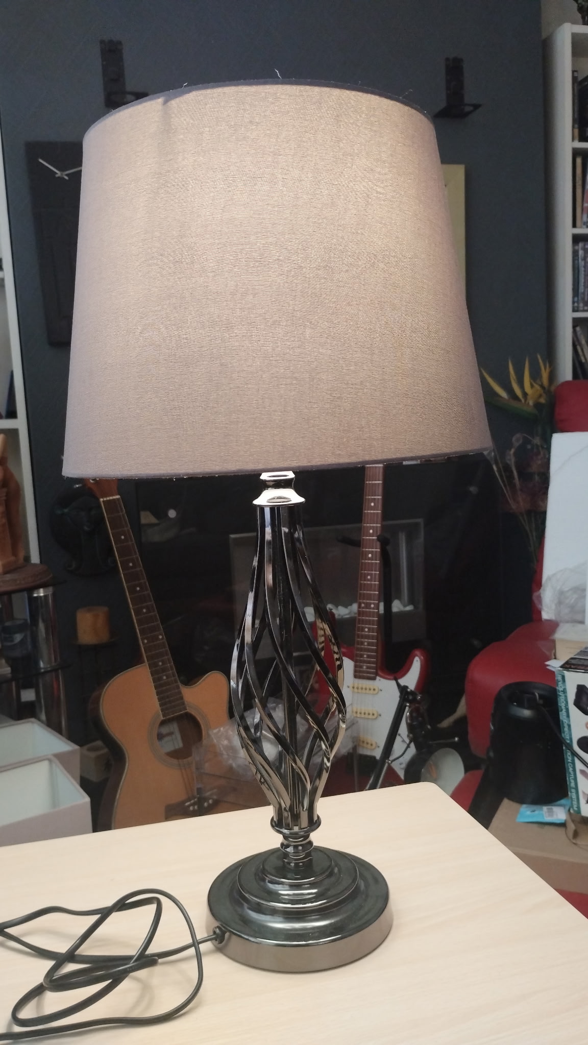 A contemporary polished chrome barley twist table lamp with taupe fabric shade