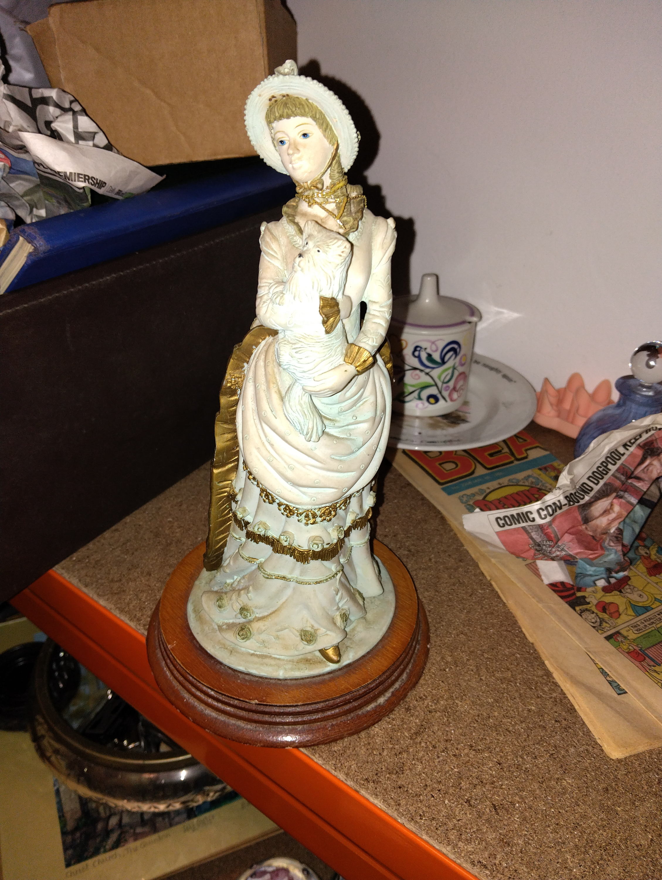 A Decorative Composite Figurine of a Victorian-Style Lady with a Dog