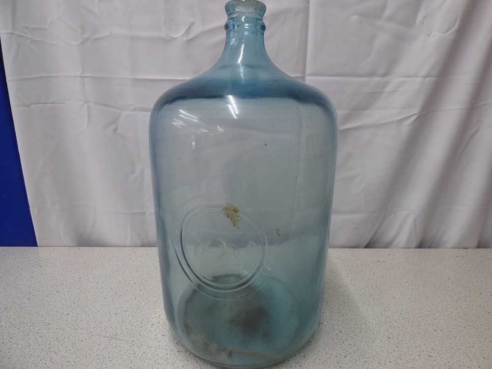 Lot 177: A Large Blue-Green Tinted Glass Carboy Demijohn with Embossed Mark