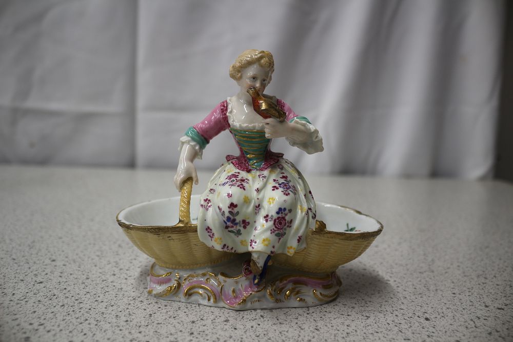 Lot 254: A Meissen Porcelain Figurine of a Woman on a Rococo Twin Dish