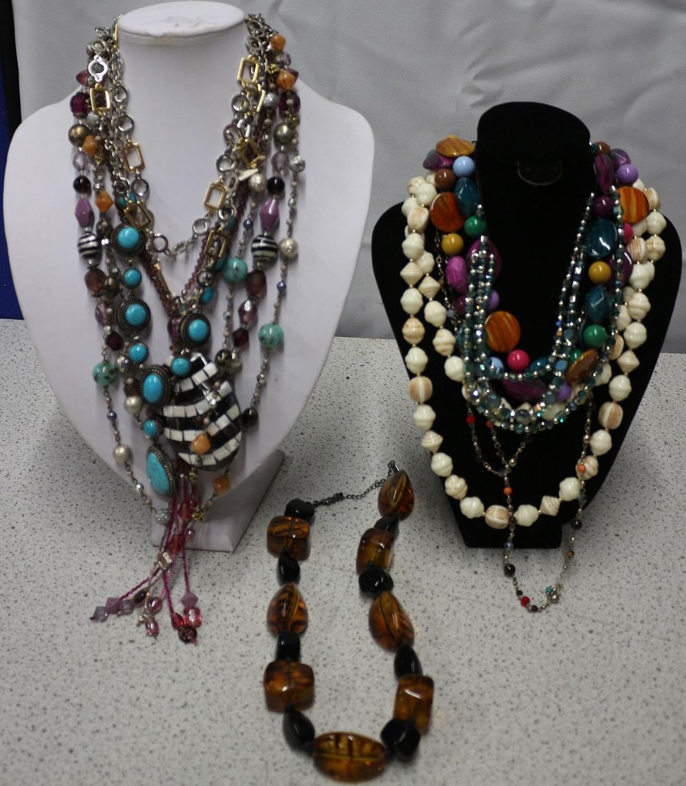 Lot 179: This lot comprises approximately 10+ assorted necklaces. The group displayed on the white mannequin features chunky, layered designs