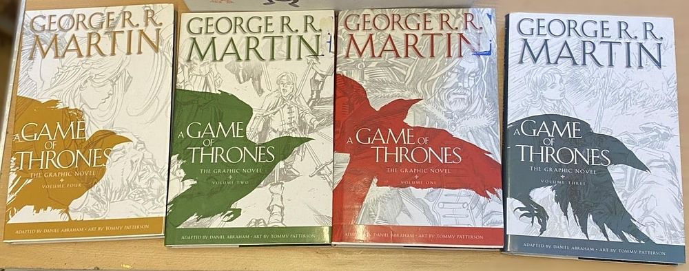 Lot 303: A Set of Four 'A Game of Thrones: The Graphic Novel' Volumes by George R. R. Martin