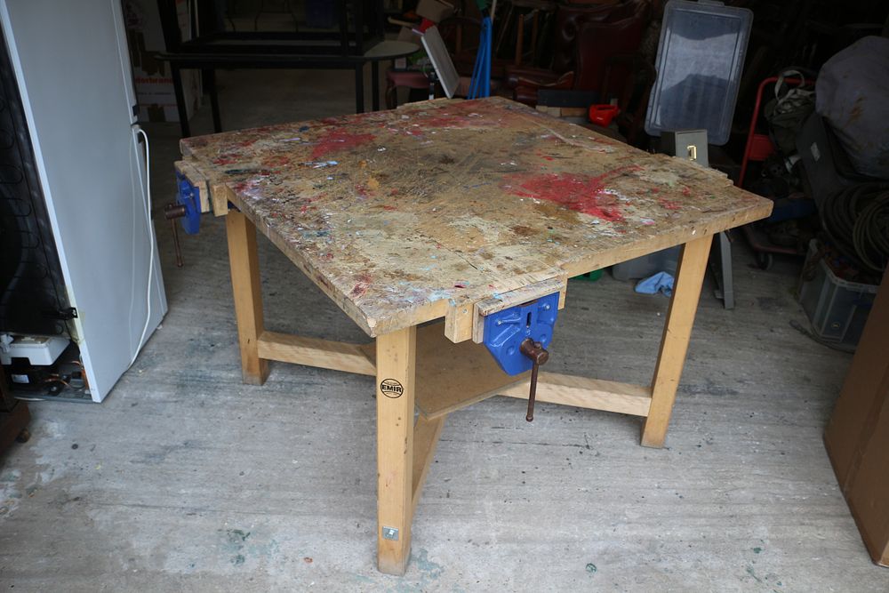 Lot 204: A Paint-Splattered Wooden Workbench with Various Vices