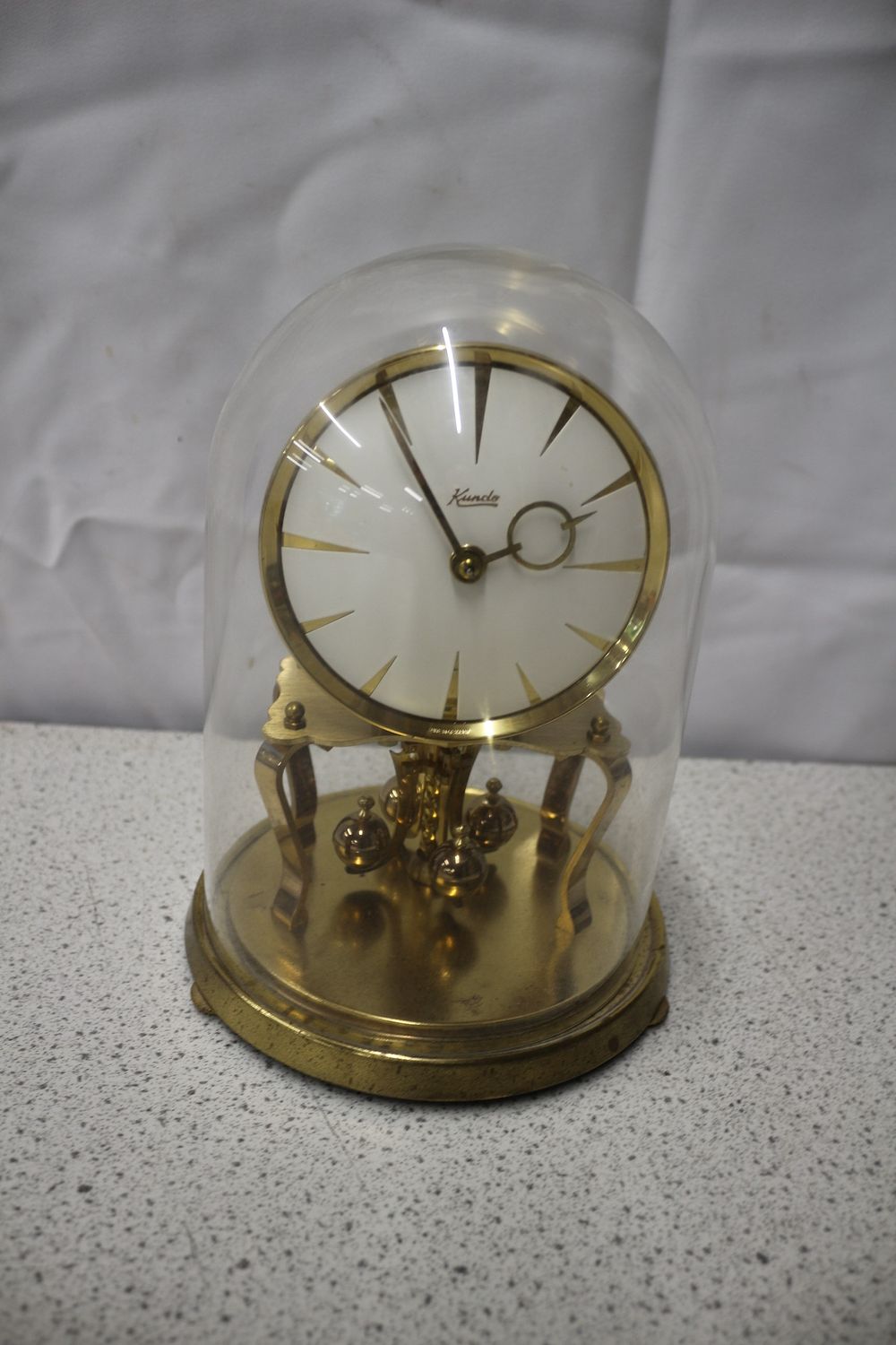 Lot 208: A Kundo Gold 400-Day Anniversary Clock with Glass Dome