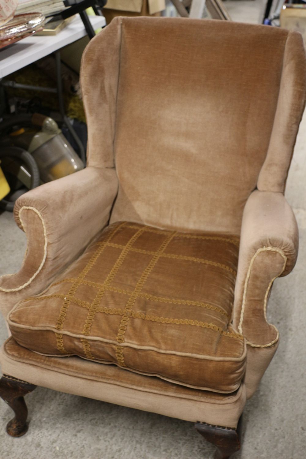 Lot 256: A Light Brown Velvet Upholstered Wingback Armchair