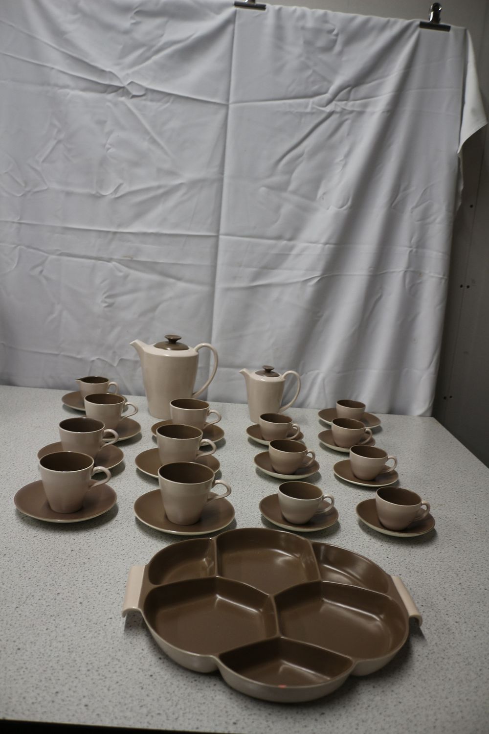 Lot 313: Poole Pottery Two-Tone Teapots, Cups, Saucers, and Platter