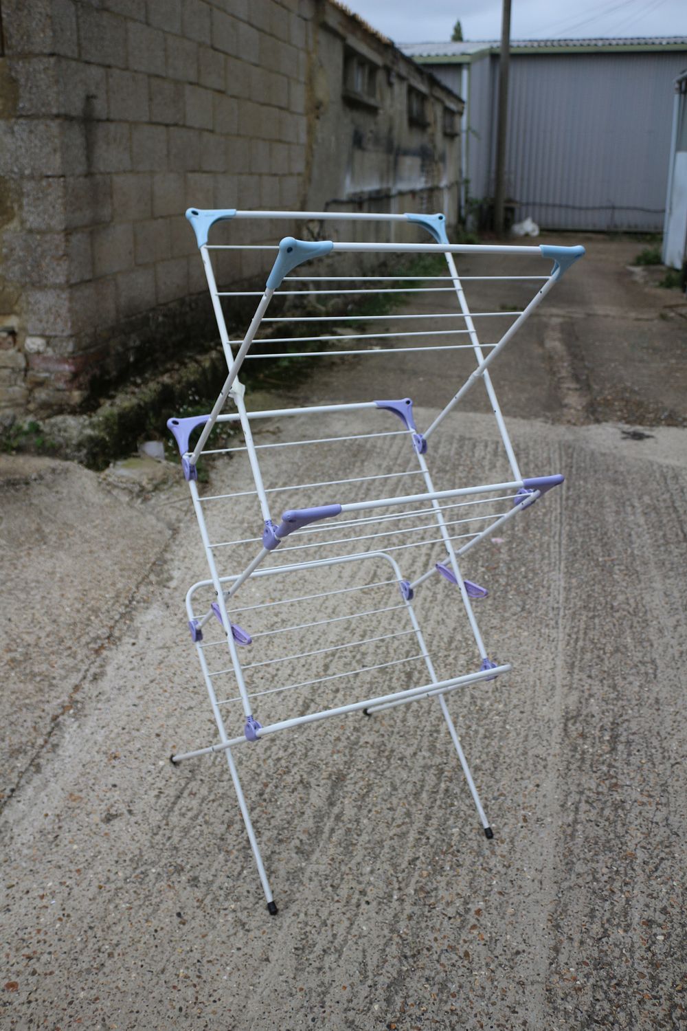 Lot 318: A White Clothes Drying Rack with Blue and Purple Accents
