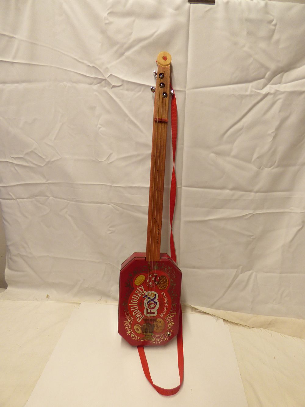 Lot 260: Biscuit Tin Guitar/Ukulele