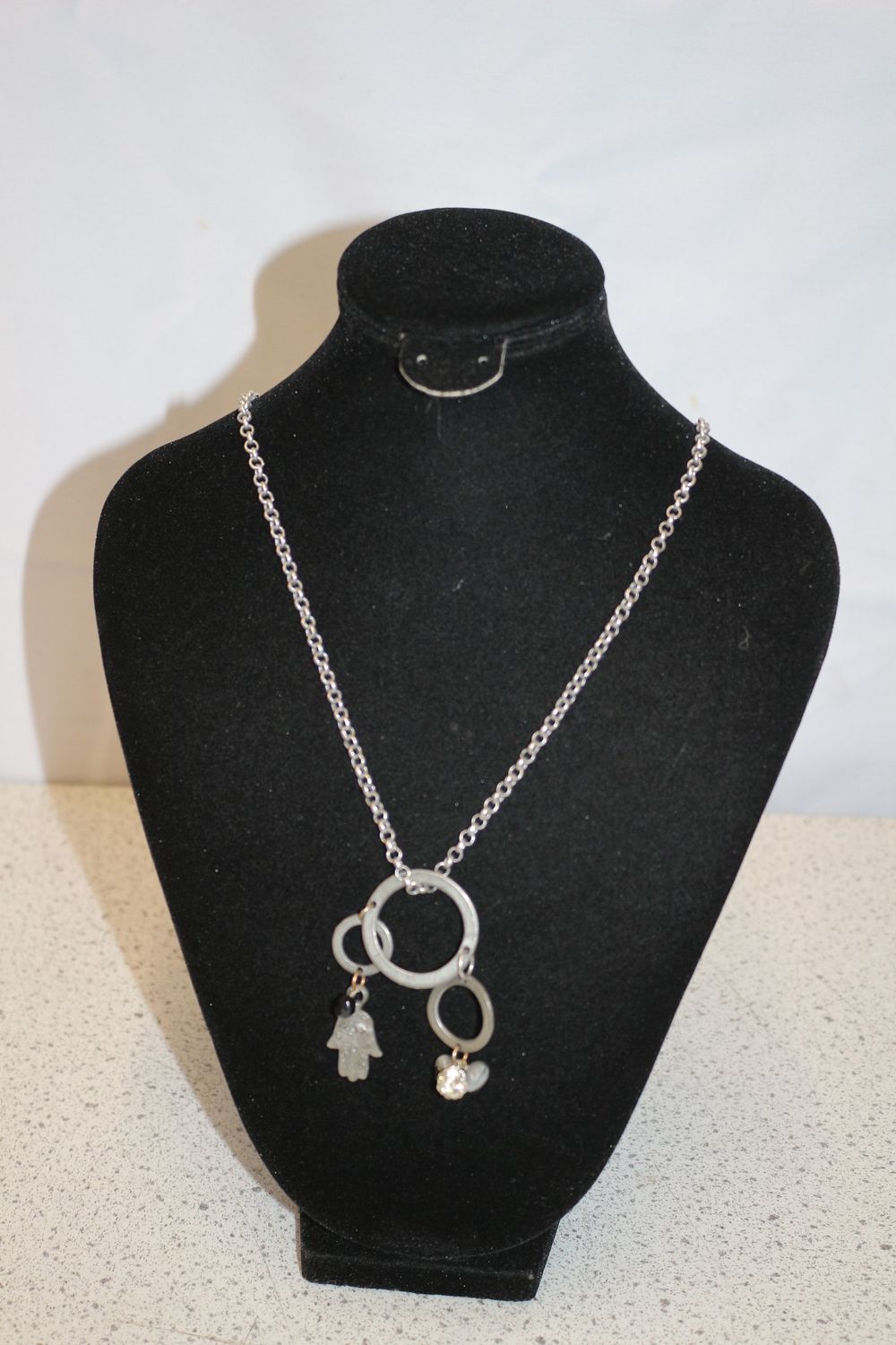 Lot 371: Silver-Toned Necklace with Hamsa and Heart Charms