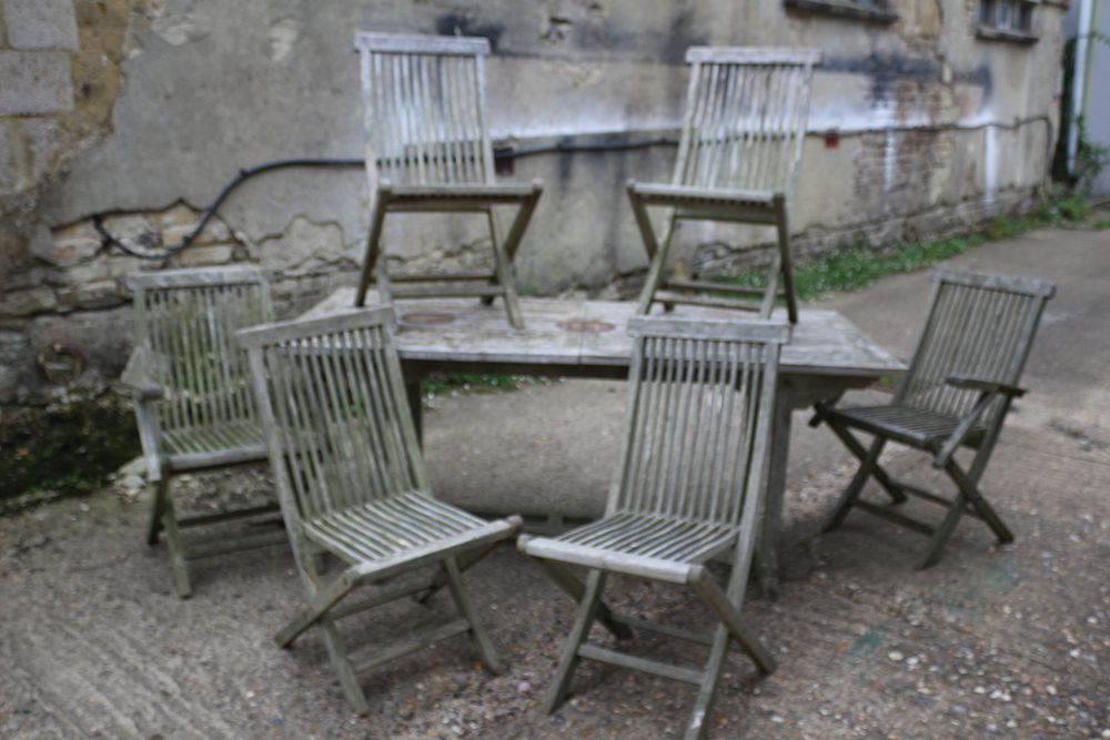 Lot 413: A Set of Weathered Wooden Dining Table and Six Folding Chairs