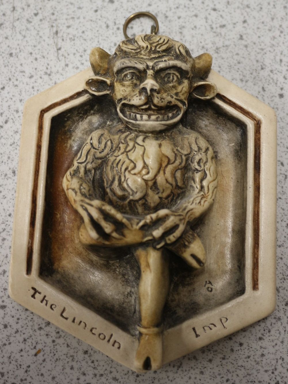 Lot 494: A Rare Cast Composite Wall Plaque Depicting The Lincoln Imp