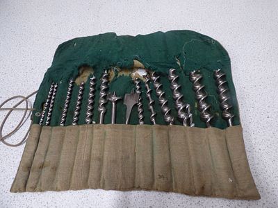 A Set of 13 Metallic Auger Drill Bits in Canvas Roll. A set of 13 metallic silver/grey auger 