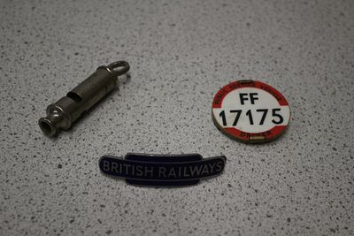 A Group of Three British Railways Badge, Whistle and Token. A metallic whistle , a blue and 