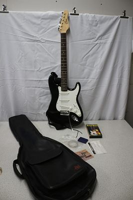 Encore Electric Guitar and Accessories. A black and white "Encore" electric guitar with a 