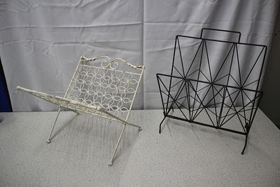 A Pair of Vintage Magazine Racks. A pair of metal magazine racks, one an off-white/cream folding 