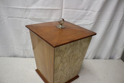 A 1930s Art Deco Wooden and Marble-Patterned Wastebasket. A lidded wastebasket, featuring a 