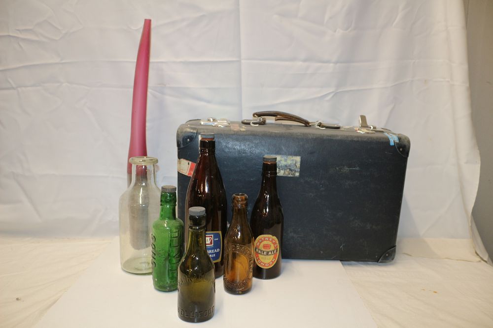 Lot 259: A Collection of Vintage Bottles, Suitcase, and Tall Signed Unusual Shaped Vase